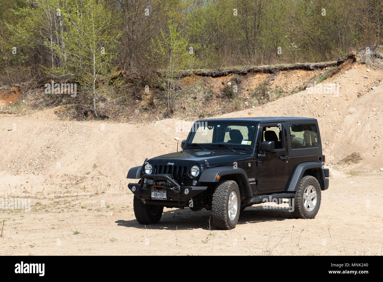 A 2016 black Jeep Wrangler Sport parked in a sand and gravel pit in the Adirondack Mountains, NY USA Stock Photo