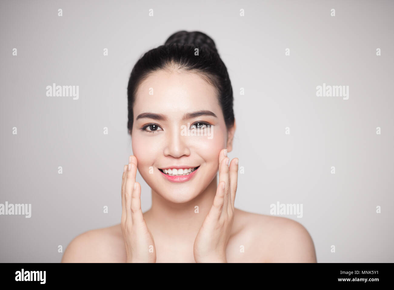 Happy smiling beautiful asian woman touching her face Stock Photo - Alamy
