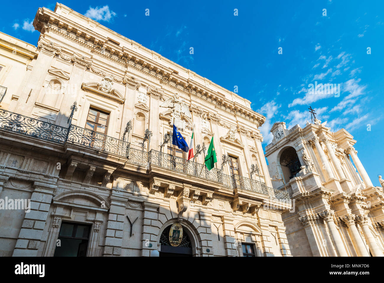 Facade of the town hall in Piazza Duomo with the cathedral in the old town of the historic city of Siracusa in Sicily, Italy Stock Photo