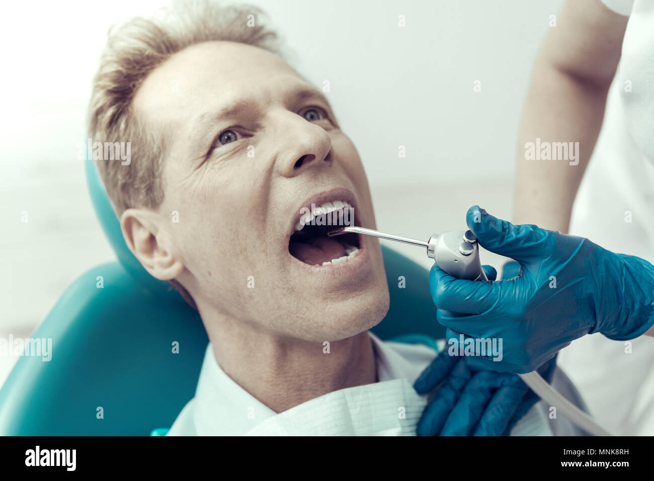 Dental engine in the mouth of a patient Stock Photo Alamy