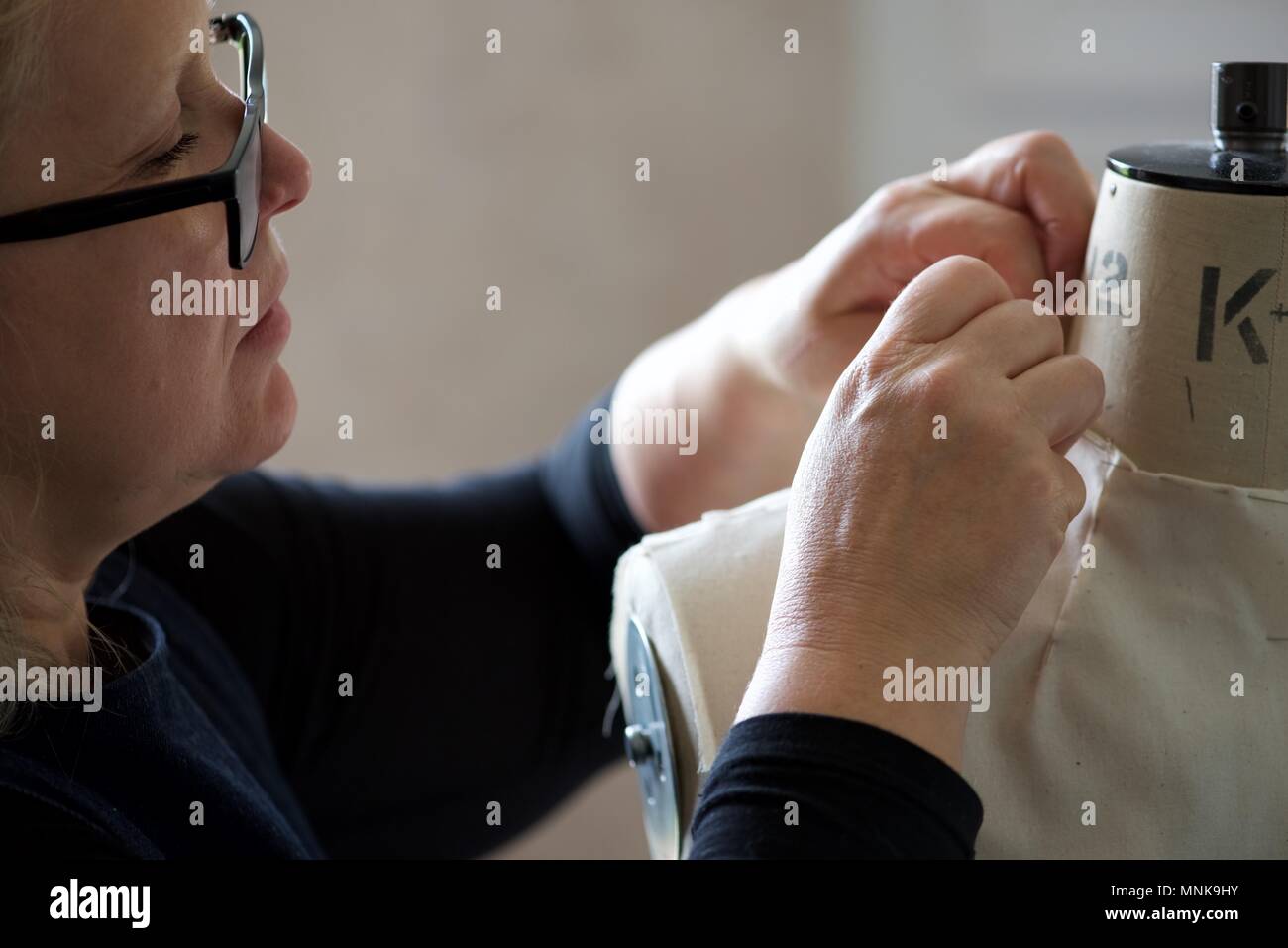 Pattern Maker (Fashion) a real Pattern Maker/Pattern Cutter at work on a calico toile on a