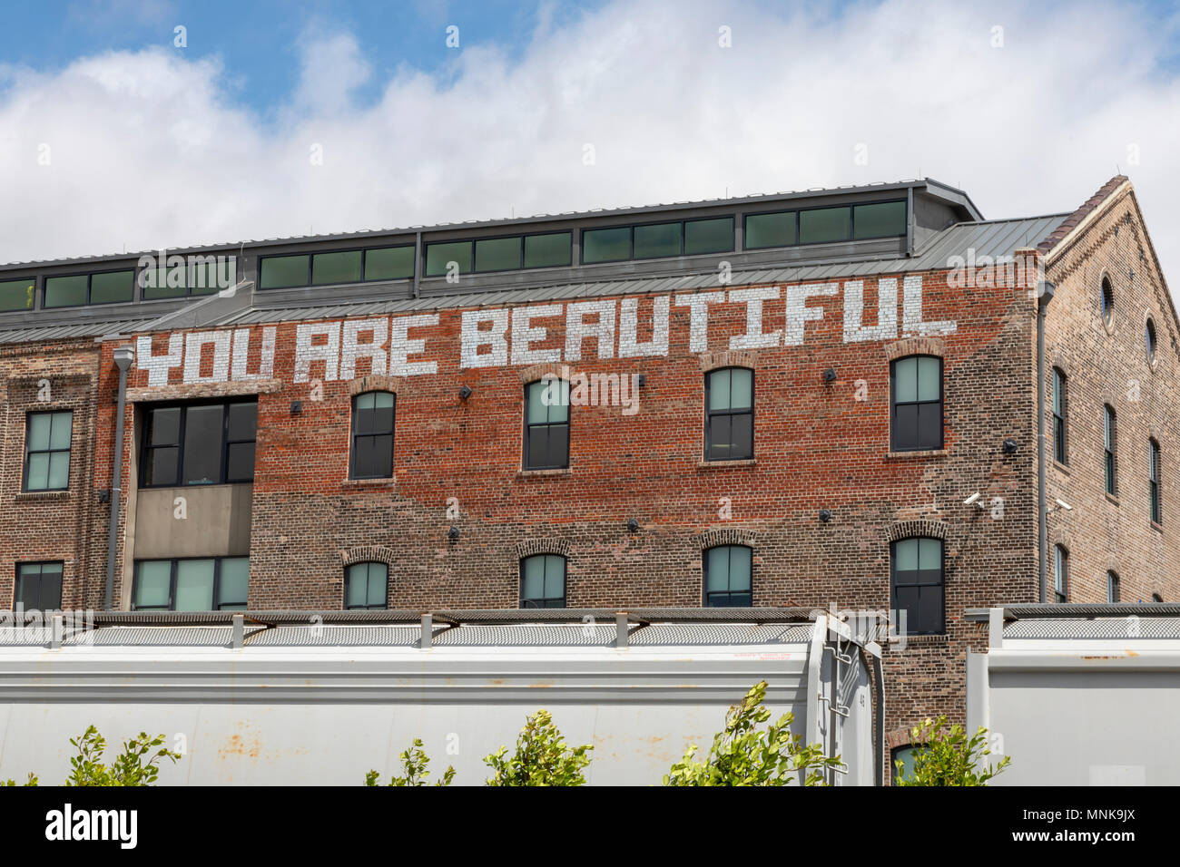 New Orleans, Louisiana - "You are Beautiful," painted on a building next to Crescent Park. Stock Photo
