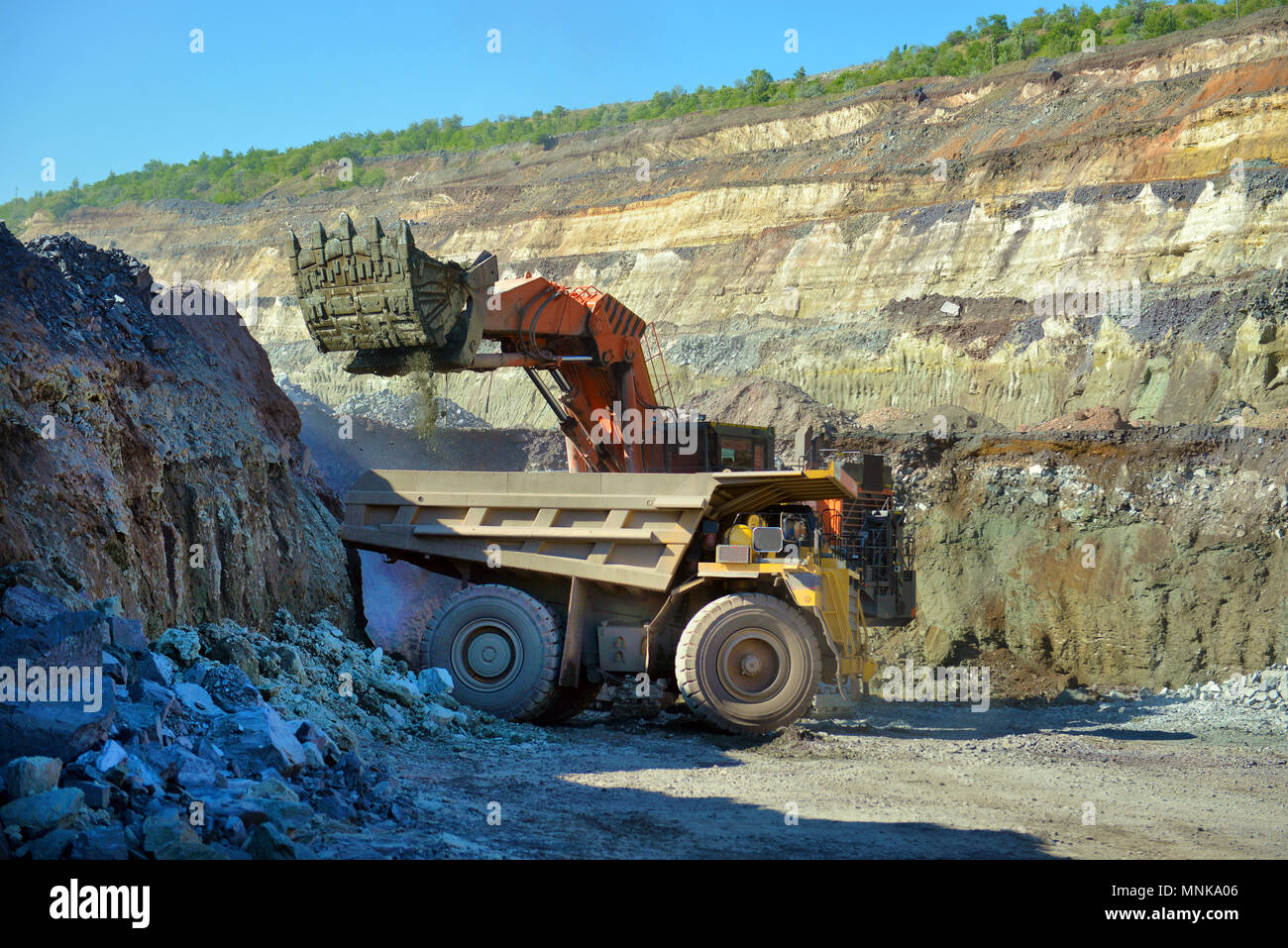 Large quarry dump truck. Loading the rock in the dumper. Loading coal into body work truck. Mining truck mining machinery, to transport coal from open Stock Photo