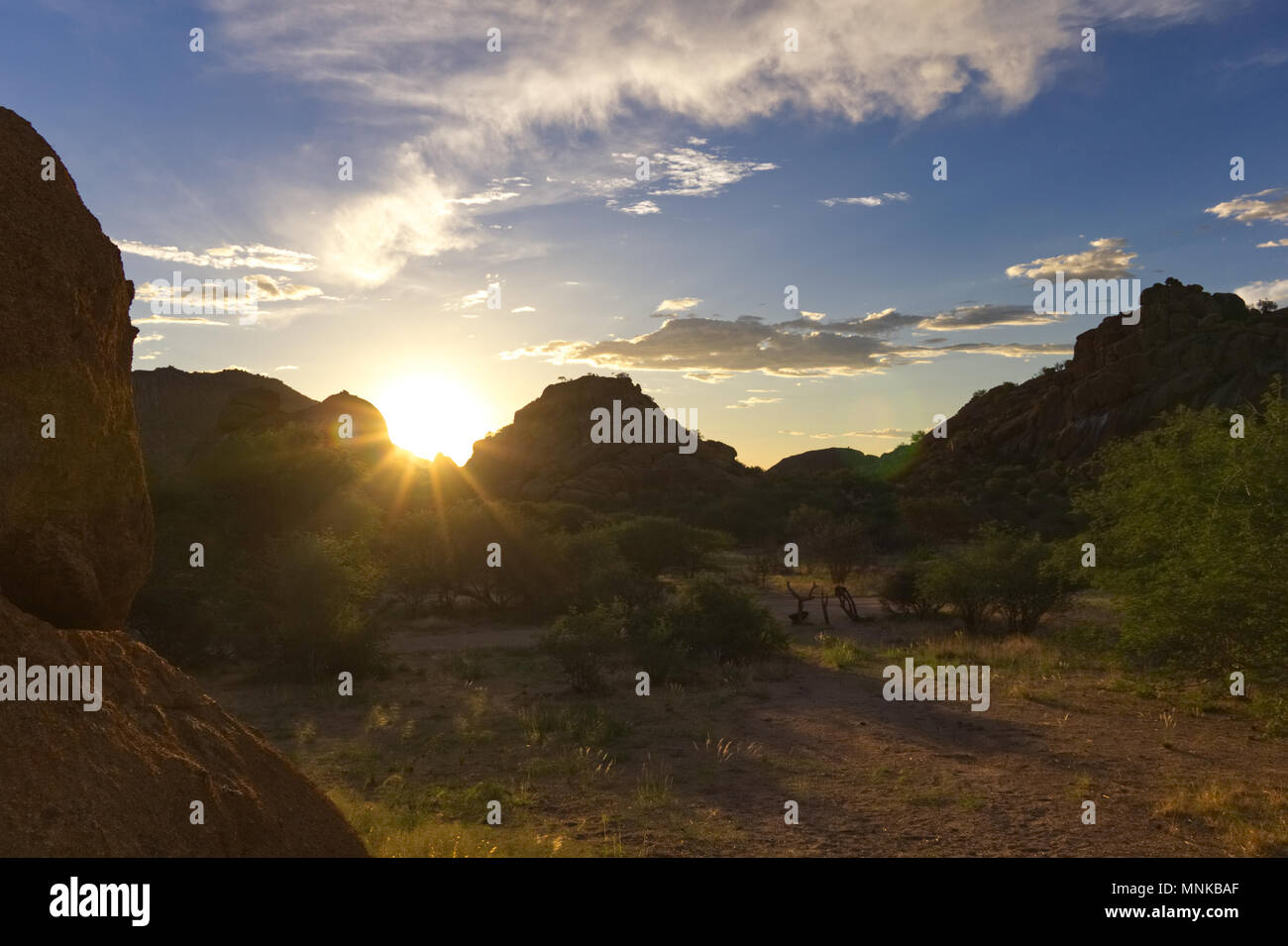 Sunset Behind Rocks Sunset behind rocks in Namibia/Africa Stock Photo - Alamy