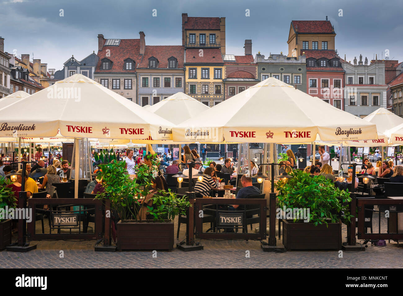Warsaw Old Town Square, on a summer evening people dine at cafe tables in the Old Town Square in the historic Stare Miasto quarter of Warsaw, Poland. Stock Photo