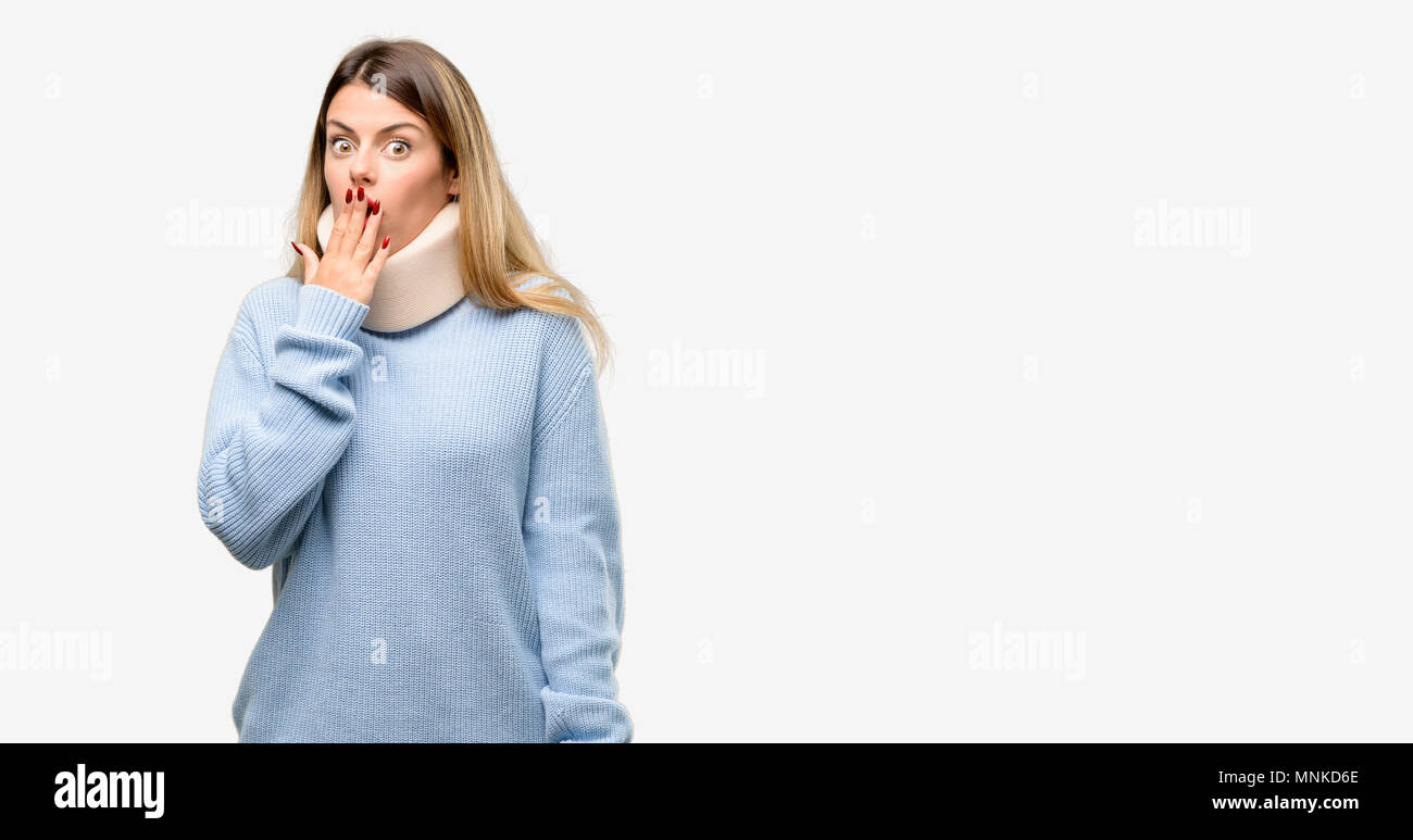 Young injured woman wearing neck brace collar covers mouth in shock, looks shy, expressing silence and mistake concepts, scared Stock Photo