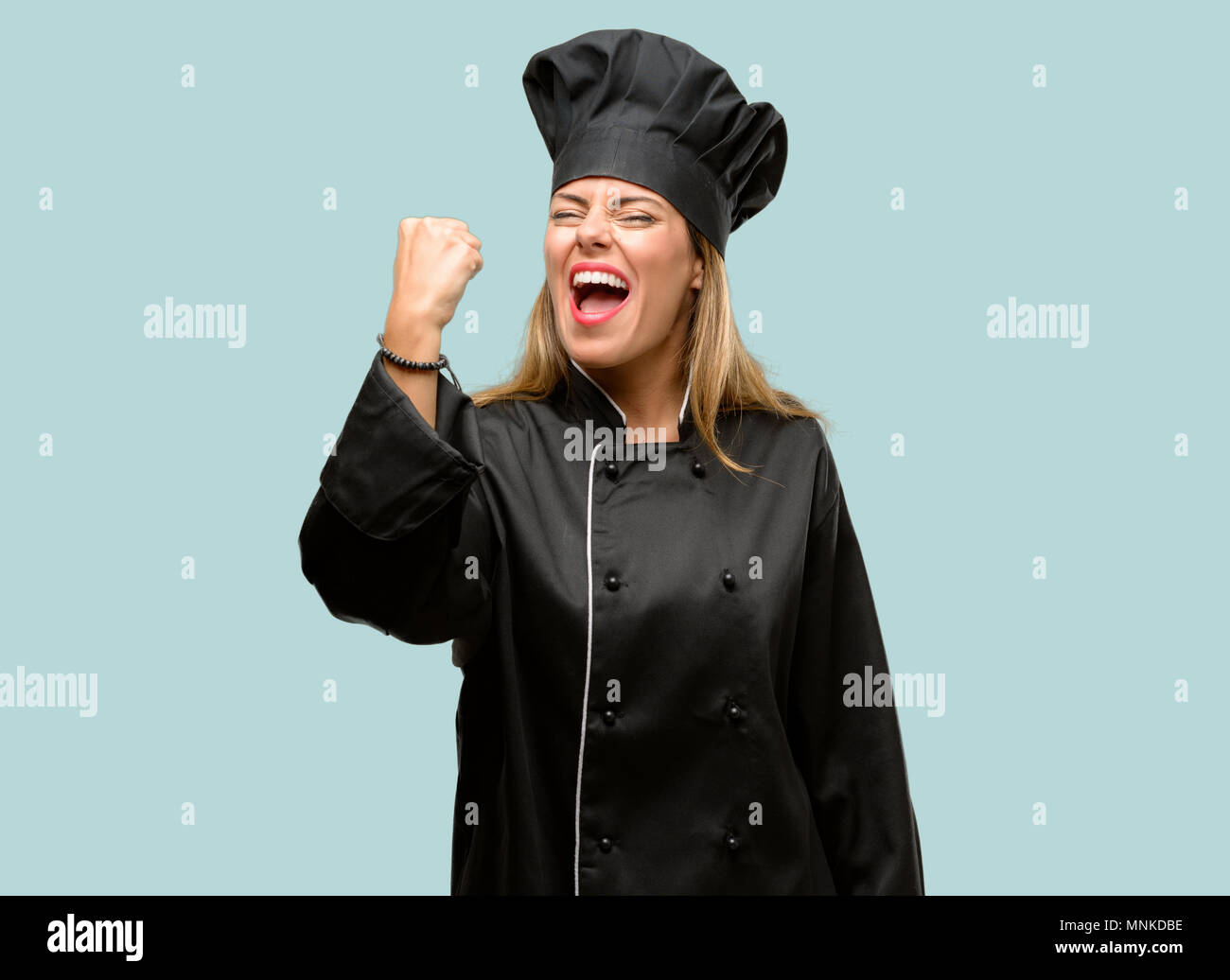 Young cook woman irritated and angry expressing negative emotion ...