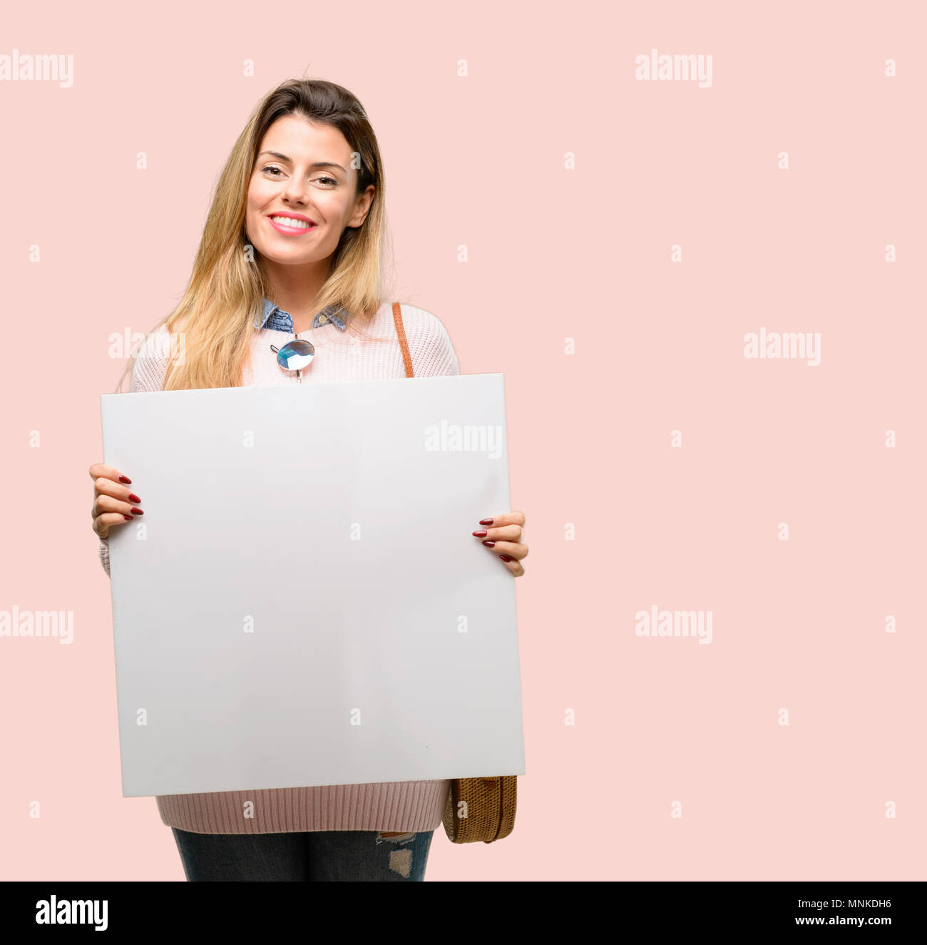 Young trendy woman holding blank advertising banner, good poster for ad ...