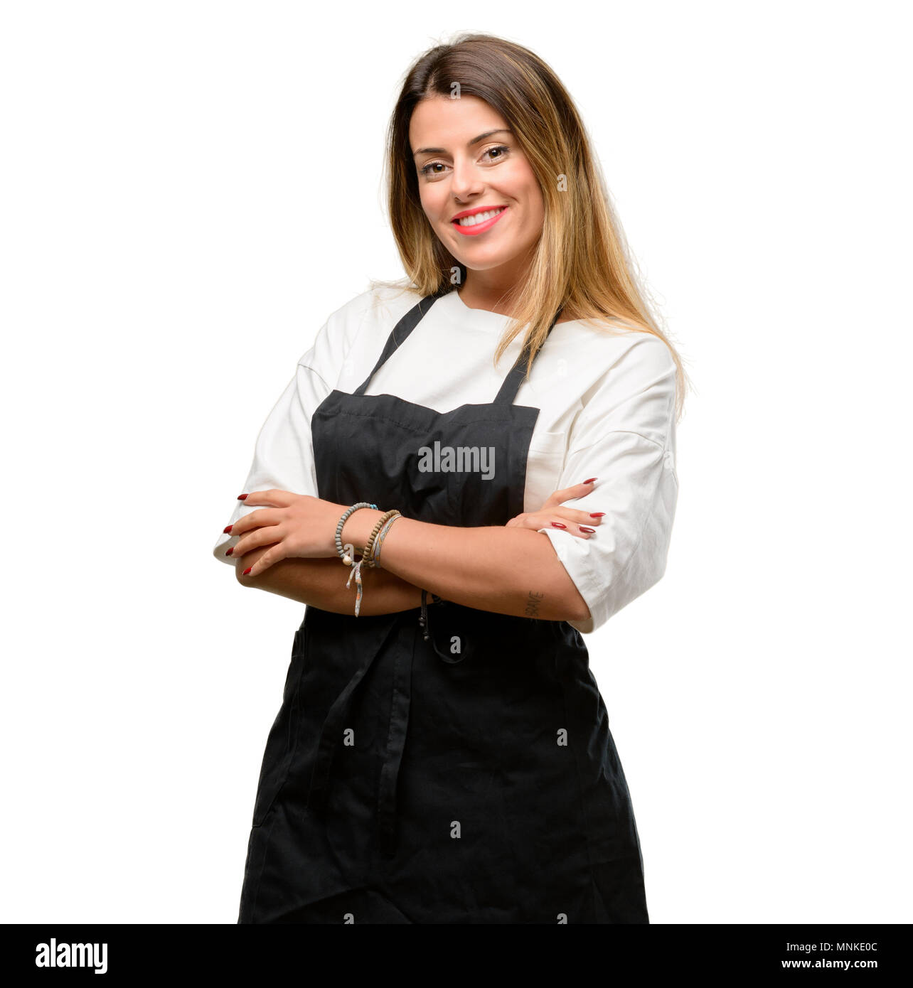 Shop owner woman wearing apron with crossed arms confident and happy with a big natural smile laughing Stock Photo