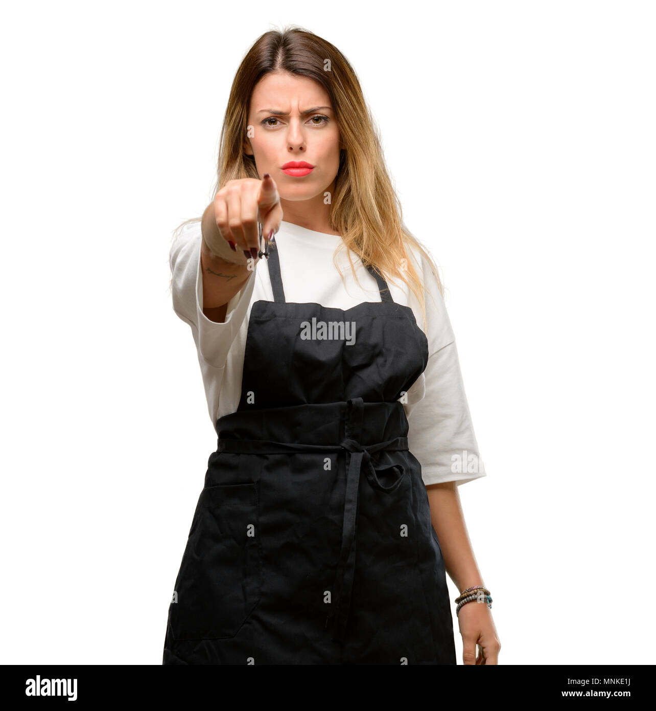 Shop Owner Woman Wearing Apron Pointing To The Front With Finger Stock