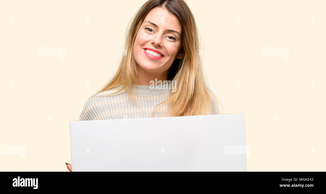 Young beautiful woman holding blank advertising banner, good poster for ...