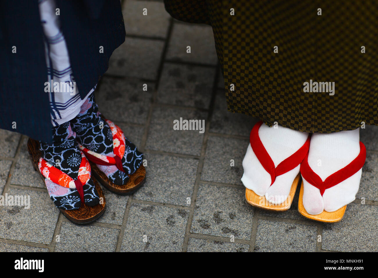 Close up of mother and daughter wearing kimono and geta traditional Japanese footwear. Stock Photo