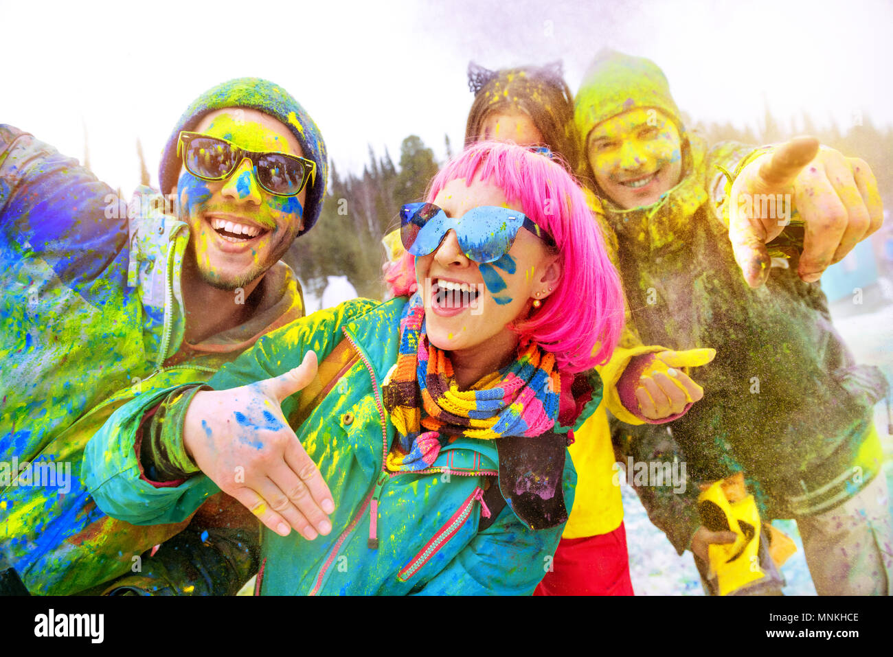 Happy friends at winter holi colors festival Stock Photo
