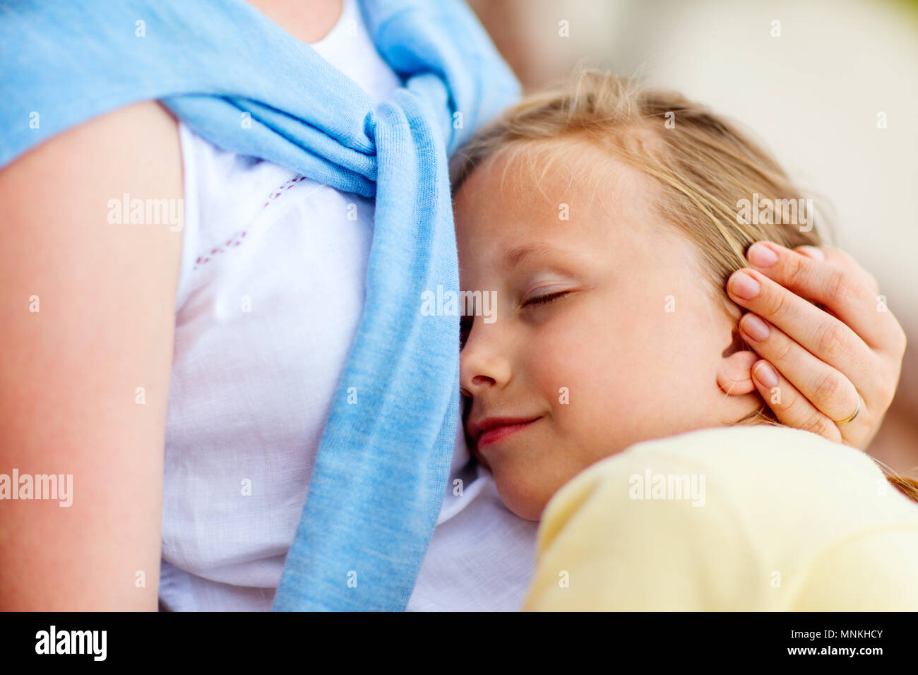 Close up of little girl sleeping on mother lap Stock Photo Alamy