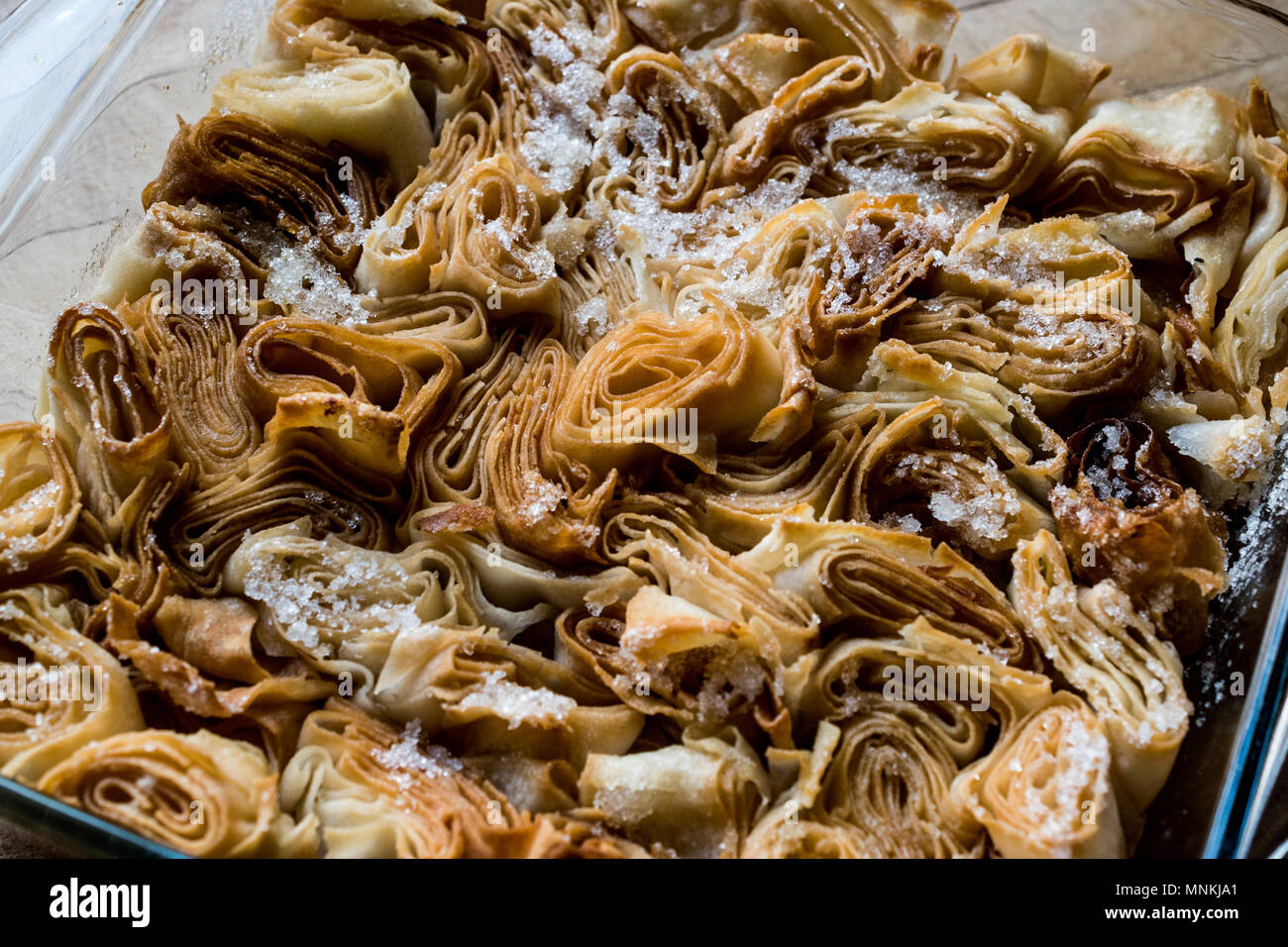 Turkish dessert From Artvin called Silor / Rolled and Fried phyllo with powdered sugar. Stock Photo