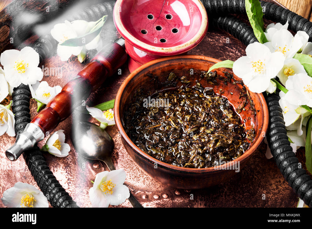 Smoke hookah with jasmine floral scent.Shisha concept.Modern hookah