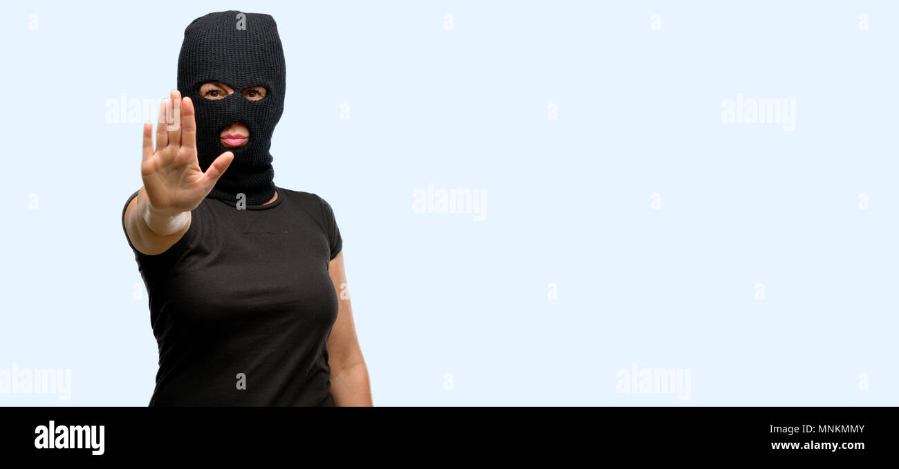 Burglar terrorist woman wearing balaclava ski mask annoyed with bad
