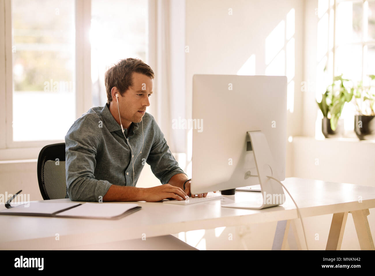 Businessman working on computer. Man sitting at his work table working on computer at home