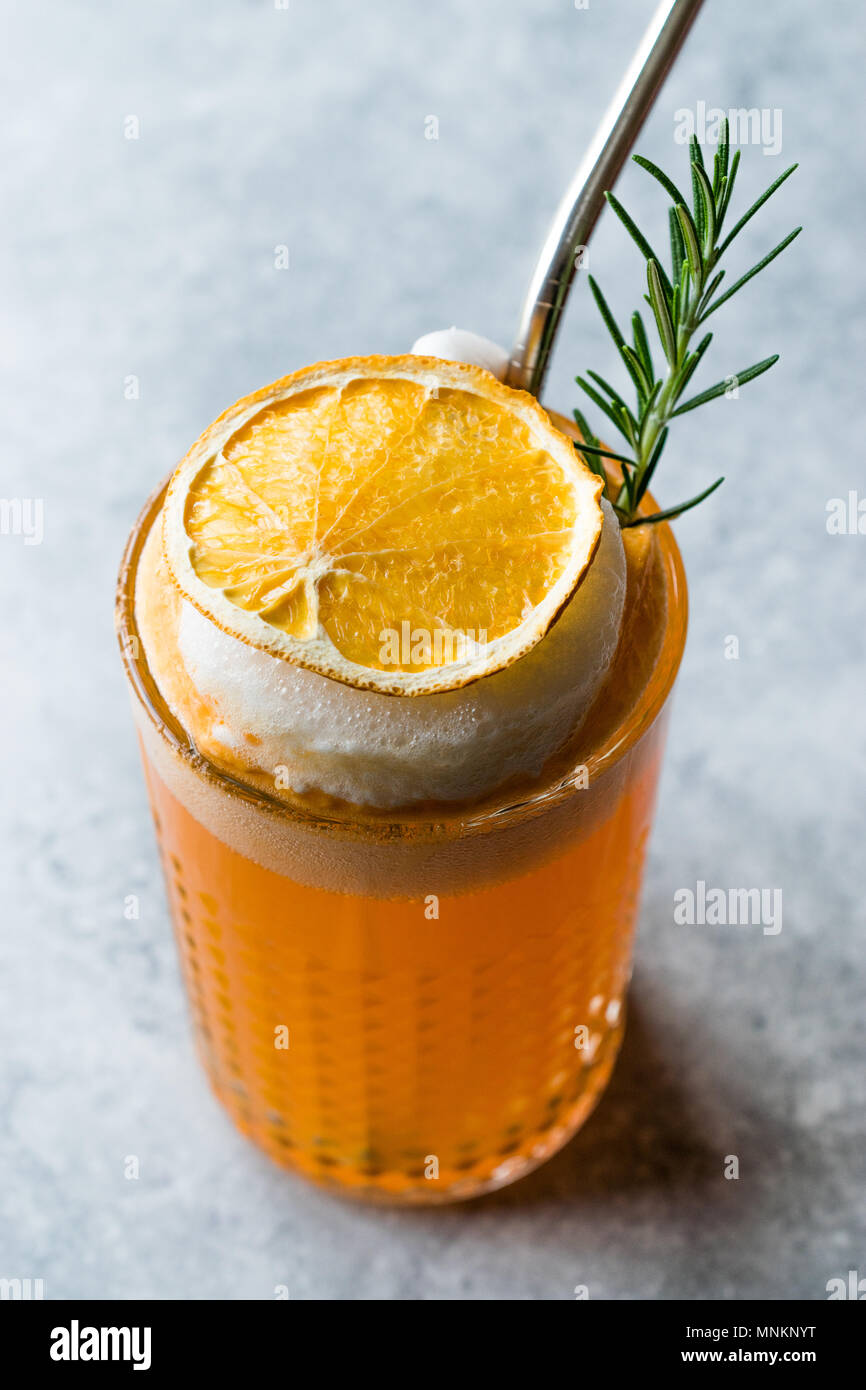 Dried Orange Cocktail with Foam, Rosemary and Metal Straw. Summer