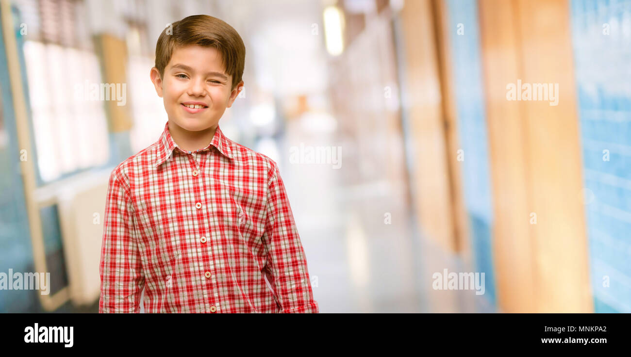 Handsome toddler child with green eyes blinking eyes with happy gesture