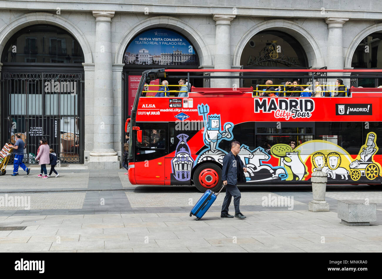 A red touristic bus in Plaza de la Ópera, Madrid city, Spain. Stock Photo