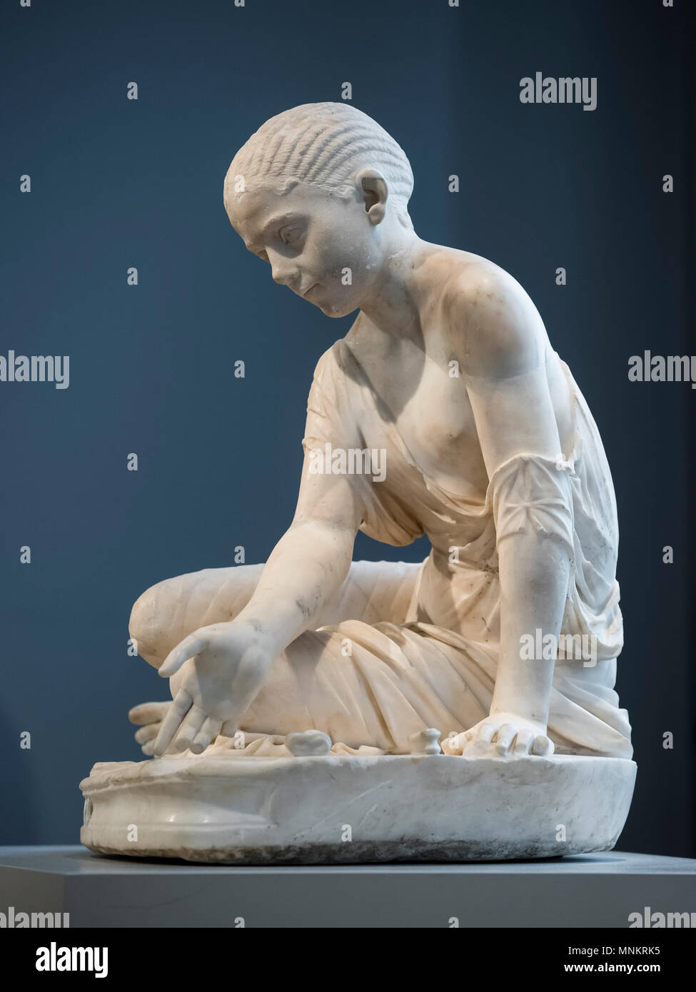 Berlin. Germany. Girl Playing Astragaloi (Knucklebones), Roman sculpture from around 150 AD, head ca. 200 AD. Altes Museum, found on the eastern slope Stock Photo