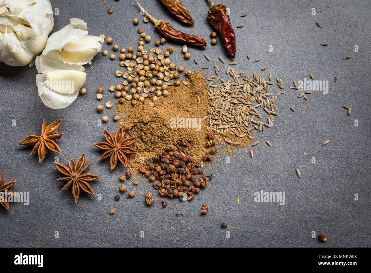 Overhead view of ingredients for cooking Asian recipe. Spices on a mid grey background Stock Photo