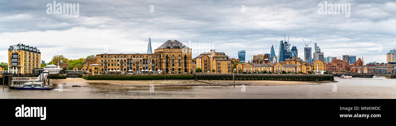Columbia Wharf (Colombia Wharf), listed building in Rotherhithe, south bank of the River Thames with London City financial district in background. Stock Photo