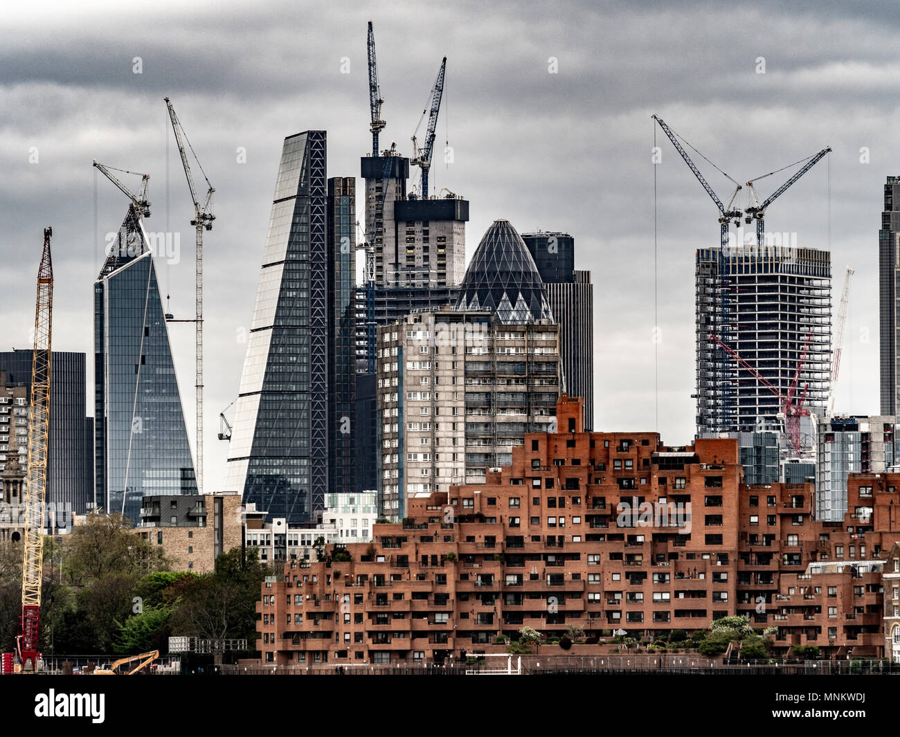 London financial district viewed from the East of the river Thames. In foreground is Free Trade Wharf: Luxury residential apartments on the north bank Stock Photo