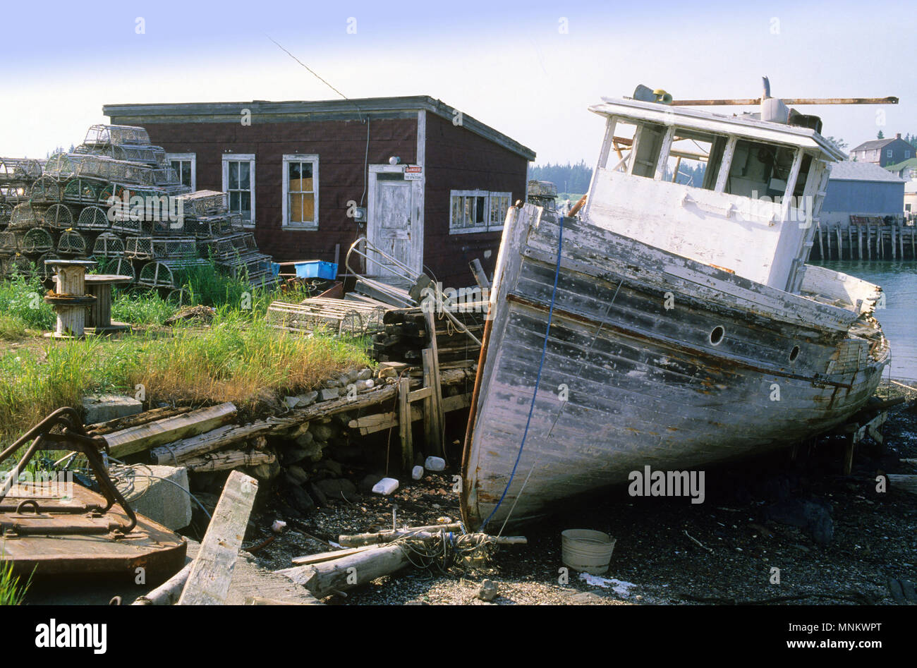 An abandoned lobster boat and yard in Port Clyde, Maine, USA Stock Photo