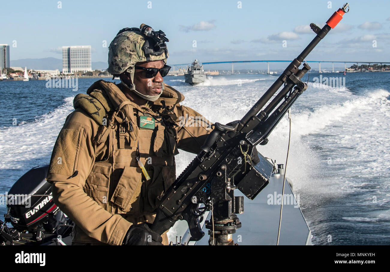 SAN DIEGO (March 15, 2018) Boatswain’s Mate 2nd Class  Ralphaell Punch, a native of Mount Union, Philadelphia assigned to Coastal Riverine Squadron (CRS) 3 mans an M240 caliber machine gun aboard MKVI patrol boat during unit level training conducted by Coastal Riverine Group (CRG) 1 Training and Evaluation Unit. CRG provides a core capability to defend designated high value assets throughout the green and blue-water environment and providing deployable Adaptive Force Packages (AFP) worldwide in an integrated, joint and combined theater of operations. Stock Photo