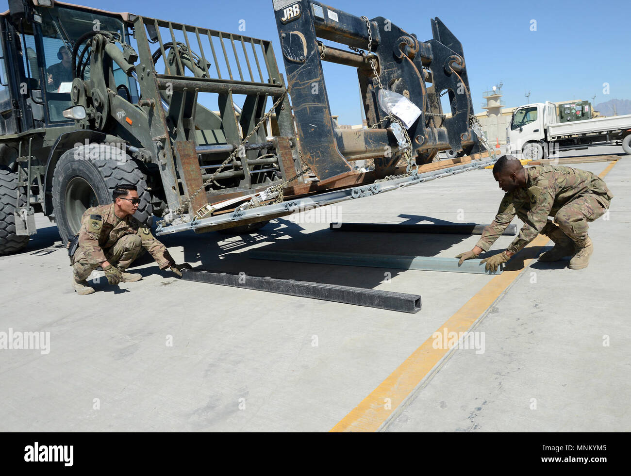 Staff Sgt. Josiah McDonald (left), 455th Expeditionary Logistic Readiness Squadron in-bound cargo NCOIC, and Senior Airman Trevis Pridgen (right), 455th ELRS traffic management technician, lay dunnage for cargo Mar. 16, 2018 at Bagram Airfield, Afghanistan. BAF is the central hub for all cargo in Afghanistan and McDonald is responsible for making sure all supplies make it to its correct destination. Stock Photo