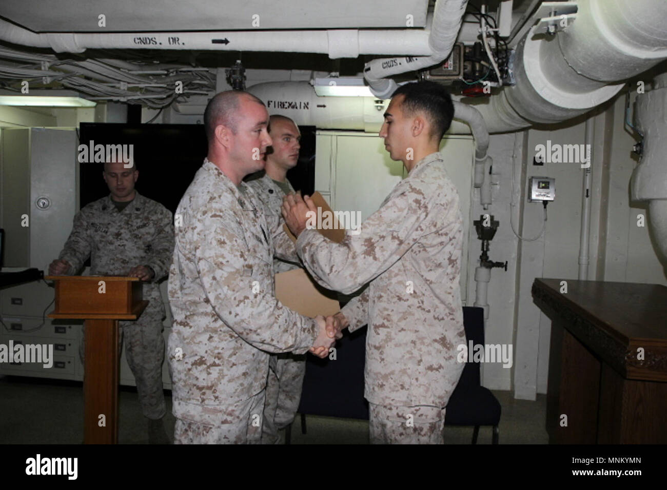 MEDITERRANEAN SEA (March 16, 2018) U.S. Marine Corps Lance Cpl. James Boncore assigned to Command Element, 26th Marine Expeditionary Unit (MEU) receives a certificate of completion during a Lance Corporal’s Leadership Seminar graduation ceremony aboard the San Antonio-class amphibious transport dock USS New York (LPD 21) March 16, 2018. The course teaches Marines ethics, values and leadership skills to develop their character and teach them the importance of small unit leadership in the U.S. Marine Corps while deployed to the U.S. 6th Fleet area of operations. U.S. 6th Fleet, headquartered in  Stock Photo