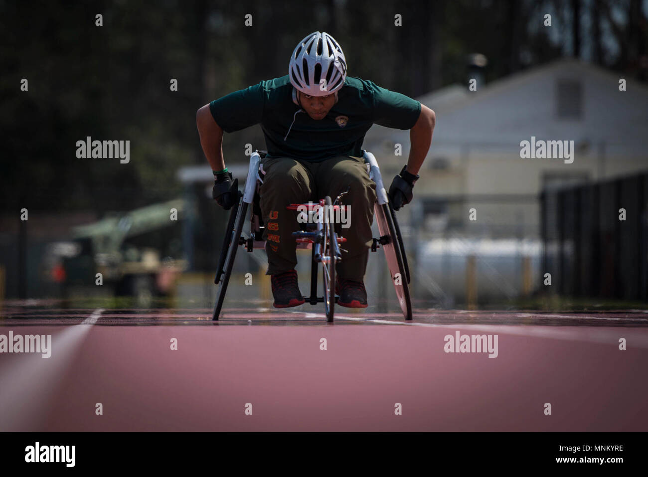 U.S. Marine Corps Cpl. Oscar Jordan practices wheelchair racing during a 2018 Marine Corps Trials track and field practice at Marine Corps Base Camp Lejeune, N.C., March 16, 2018. The Marine Corps Trials promotes recovery and rehabilitation through adaptive sport participation and develops camaraderie among recovering service members (RSMs) and veterans. It is an opportunity for RSMs to demonstrate their achievements and serves as the primary venue to select Marine Corps participants for the DoD Warrior Games. Stock Photo