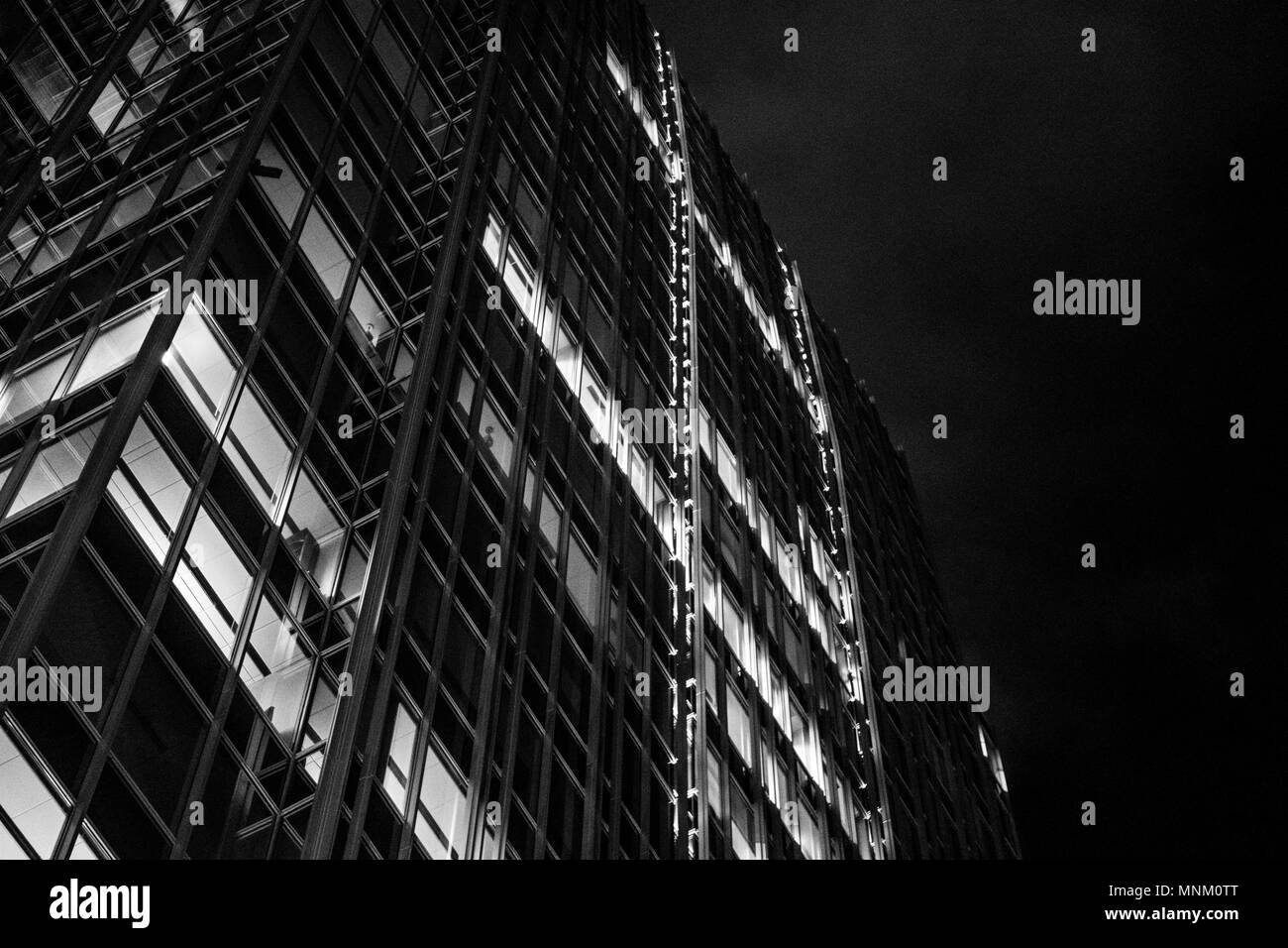 A black and white photo of a skyscraper with added grain to give a noire, old film look Stock Photo