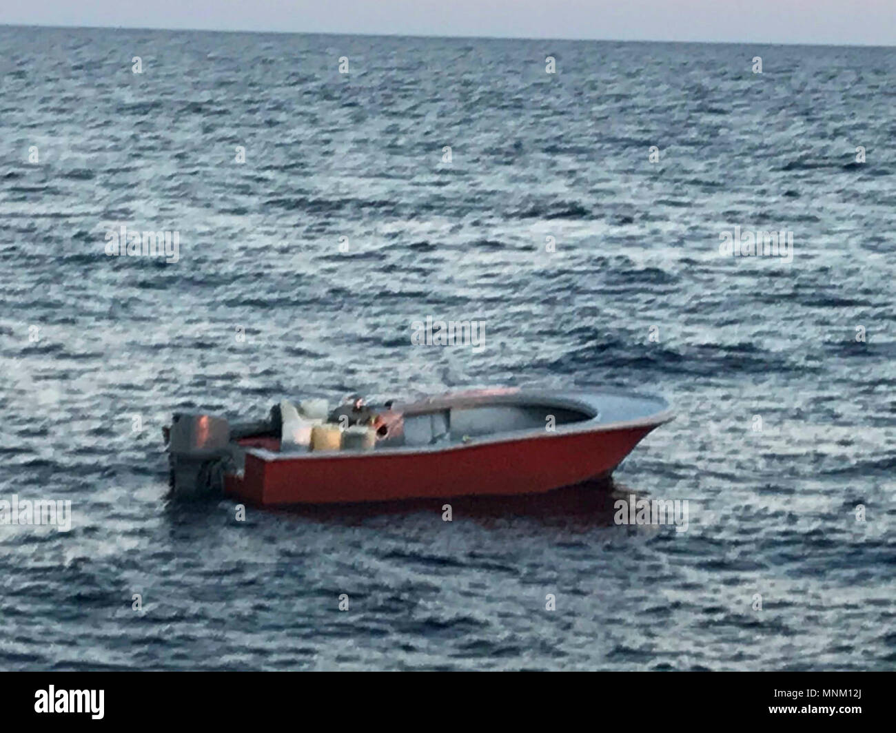 An 18foot center console floats on the water approximately 15 miles