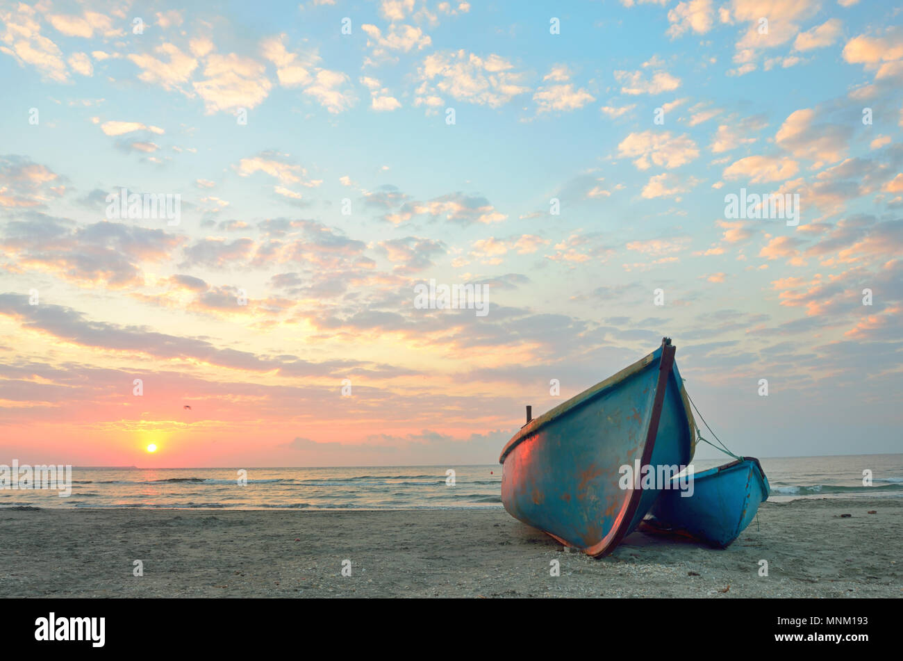 Fishing boats on the beach at sunrise Stock Photo Alamy