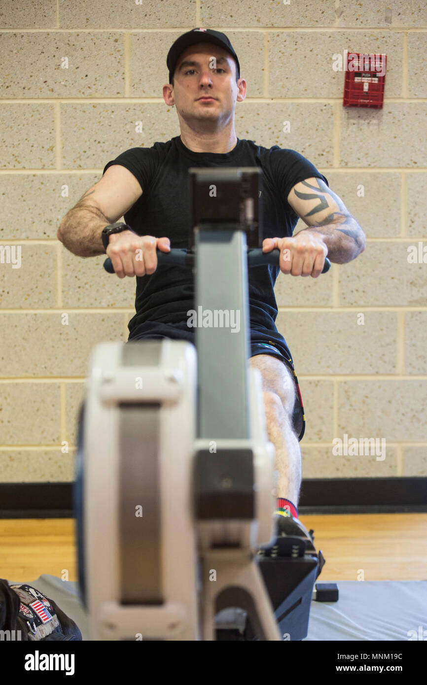 A Royal Marine athlete practices his form during a 2018 Marine Corps Trials rowing practice at Marine Corps Base Camp Lejeune, N.C., March 17, 2018. The Marine Corps Trials promotes recovery and rehabilitation through adaptive sport participation and develops camaraderie among recovering service members (RSMs) and veterans. It is an opportunity for RSMs to demonstrate their achievements and serves as the primary venue to select Marine Corps participants for the DoD Warrior Games. Stock Photo