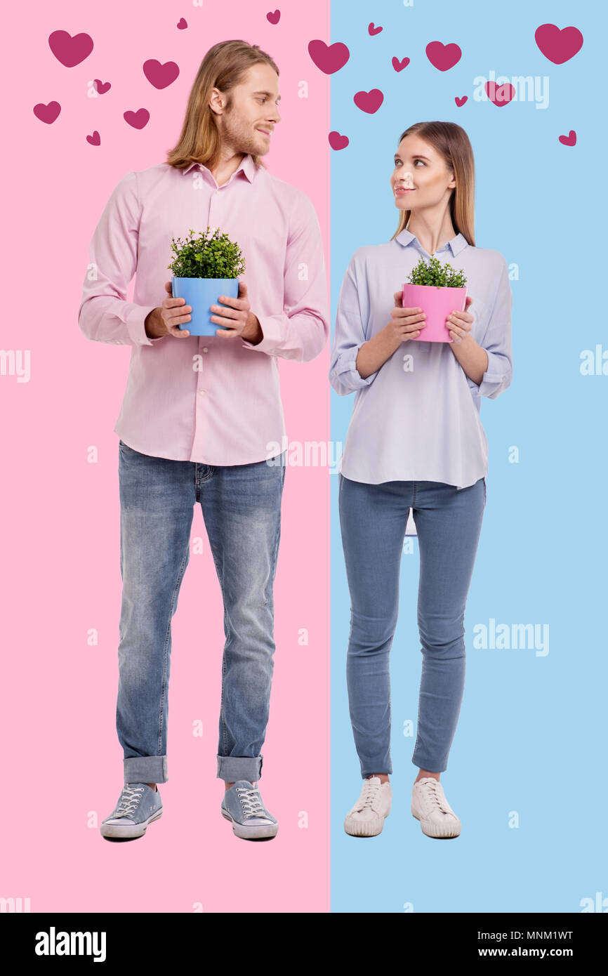 Romantic couple buying flowers after moving to a new house Stock Photo