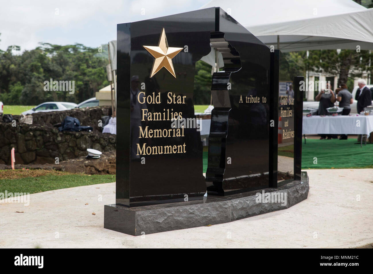 A dedication ceremony is held for the opening of a memorial monument for Gold Star Families at the Hawaii Memorial Park, Kaneohe, Hawaii, Mar. 17, 2018. Multiple organizations including federal, state and local members helped support the construction of a stone memorial honoring the Gold Star Families who have lost loved ones, while serving in the U.S. military. The Gold Star Families Memorial Monument Foundation was created by WWII Medal of Honor recipient Hershel “Woody” Williams in 2010 to remember families who have made the ultimate sacrifice. Stock Photo