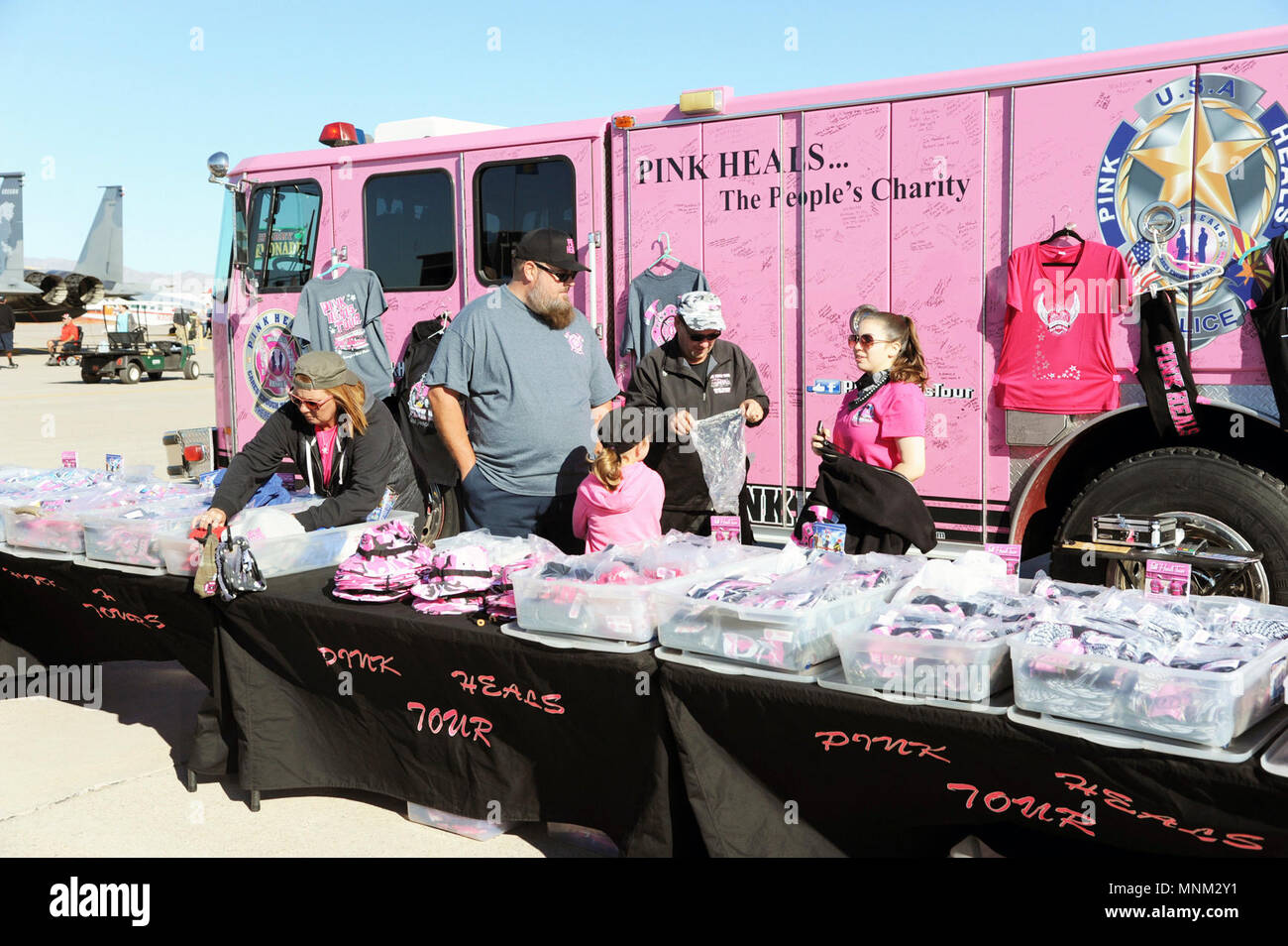 Members of the Pink Heals Tour display merchandise during Luke Days at Luke Air Force Base, Ariz., March 18, 2018. Luke Days highlights the capabilities of modern military and civilian airpower through the display of more than two dozen live air and ground demonstrations, static aircraft exhibits, and concessions to hundreds of thousands of visitors from around the world. Stock Photo