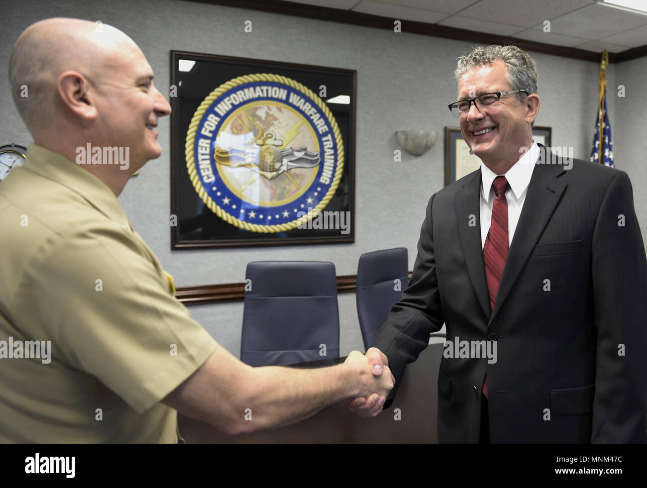 Fla. (March 19, 2018) Capt. Bill Lintz, commanding officer of the Center for Information Warfare Training (CIWT), welcomes onboard Jim Hagy, CIWT's new executive director. As executive director, Hagy will provide advice and assistance to the commanding officer in both operational and strategic matters. Stock Photo