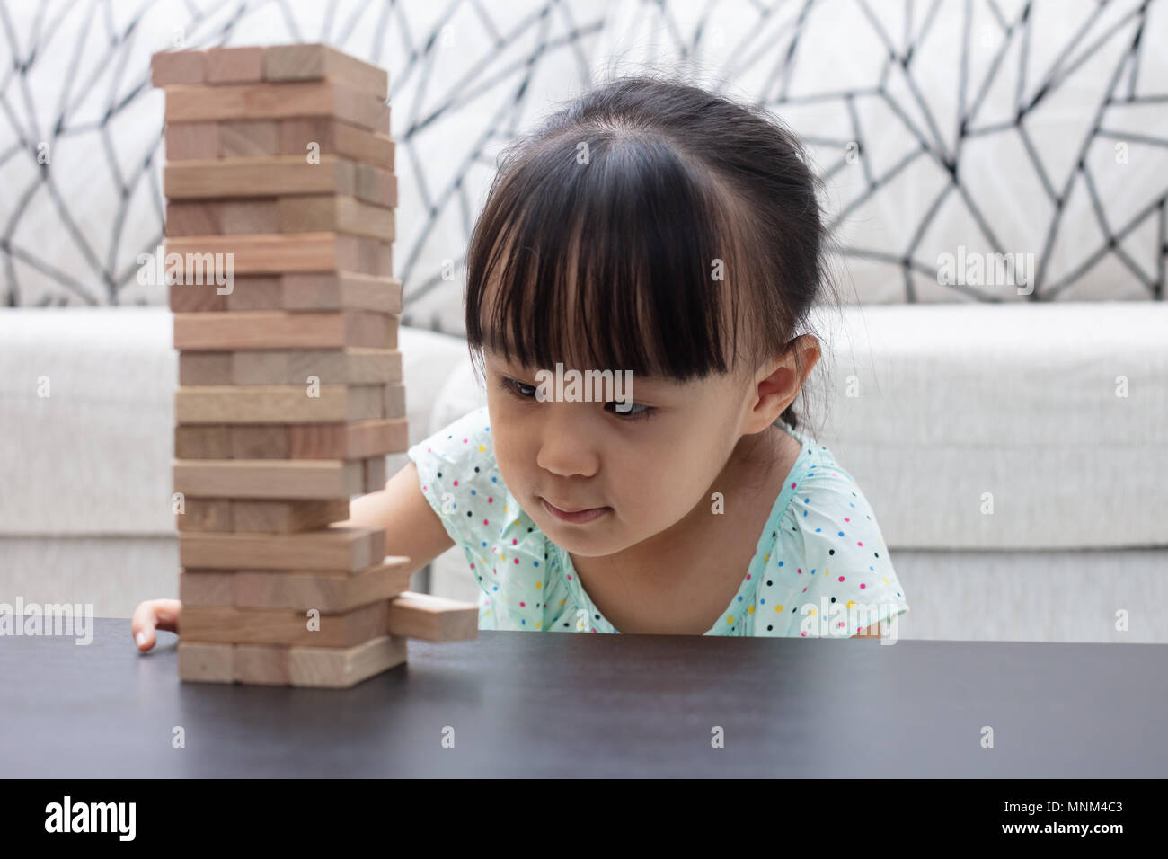 Asian Chinese little girl playing wooden stacks at home Stock Photo - Alamy