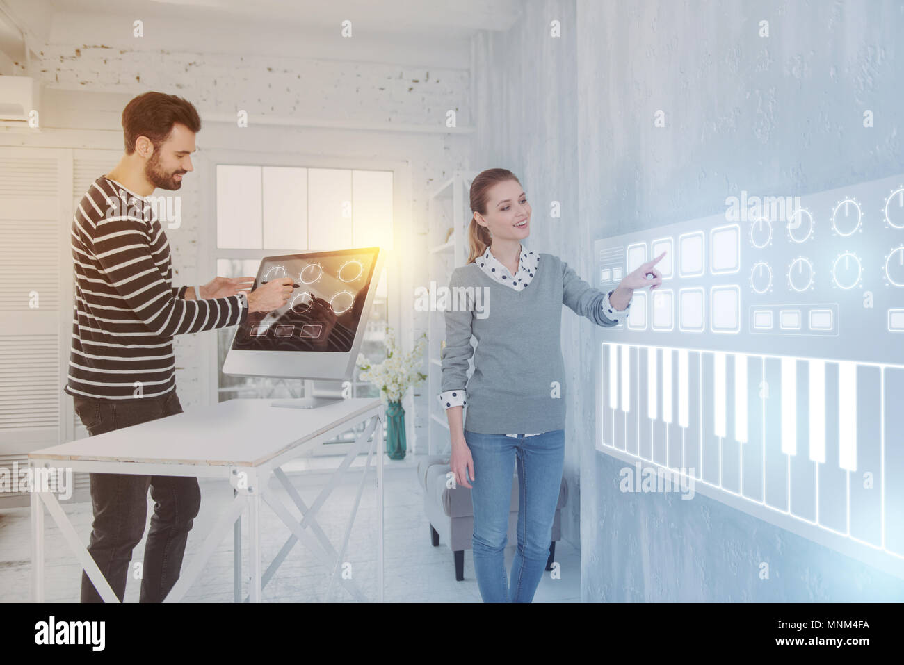 Clever programmer pointing to the screen while working with a colleague Stock Photo