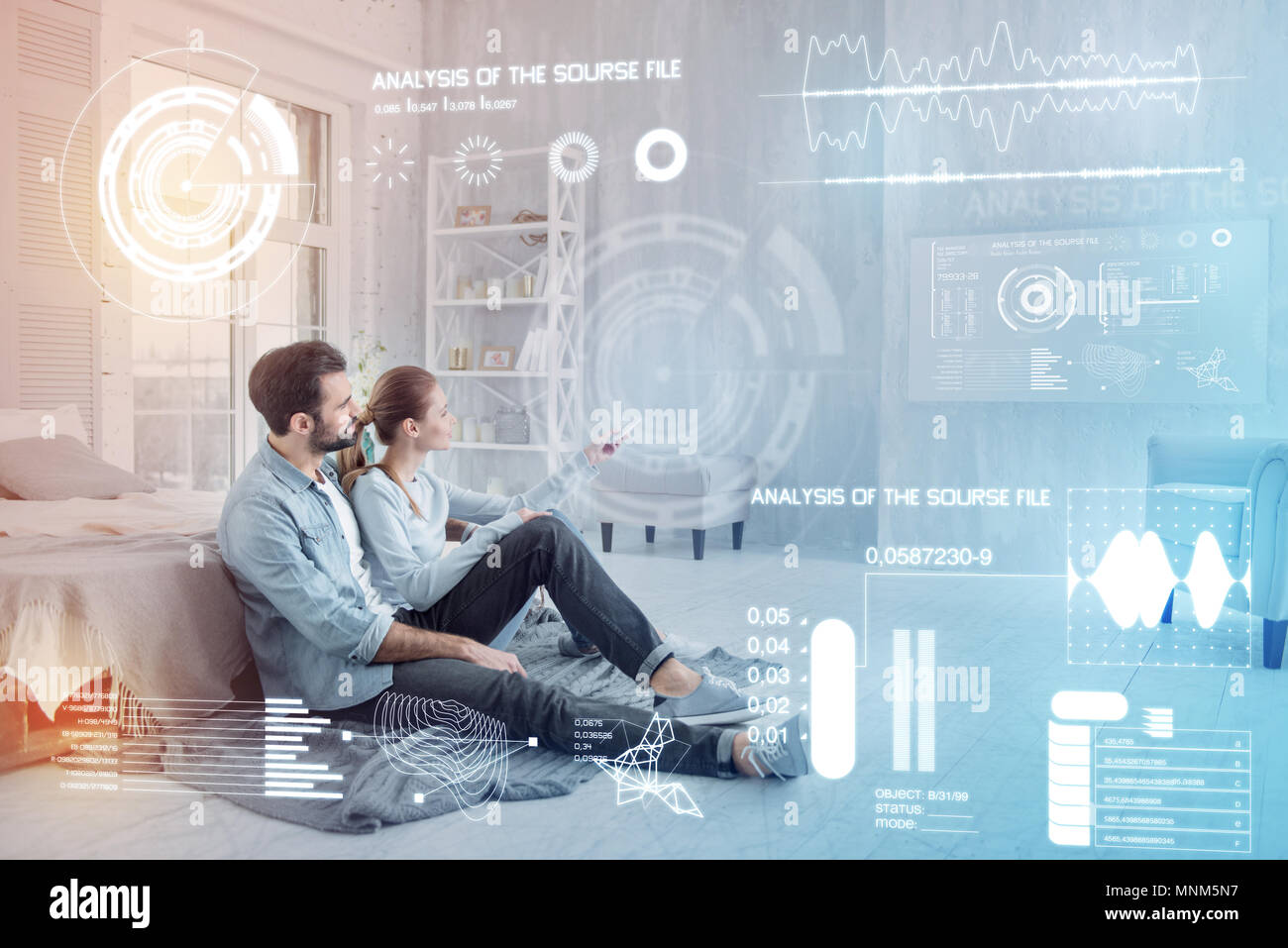 Beautiful couple sitting comfortably and watching films Stock Photo