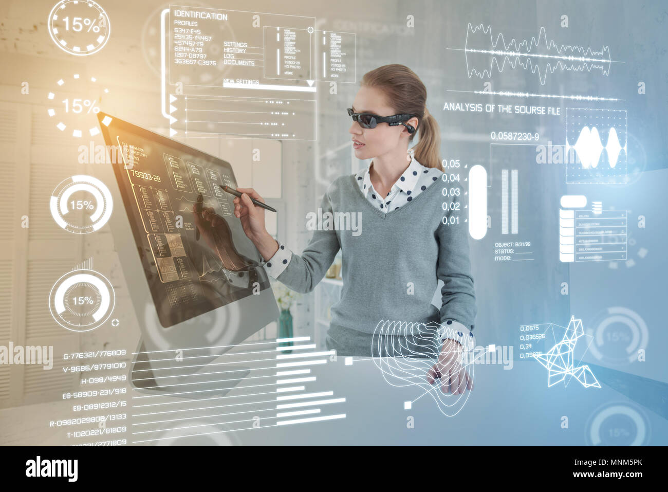 Smart database administrator wearing virtual reality glasses while working Stock Photo