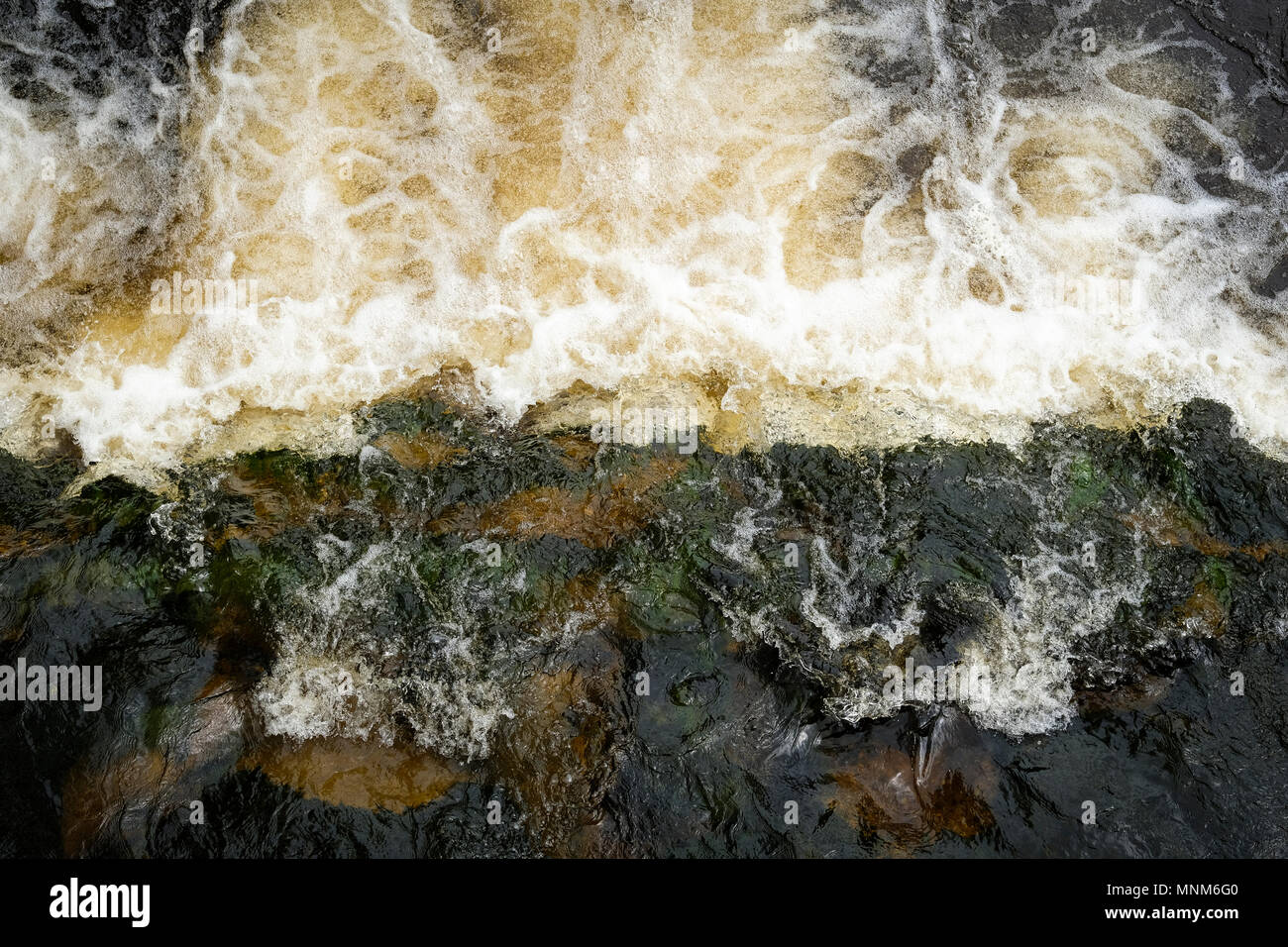 Water flowing over rocks Stock Photo