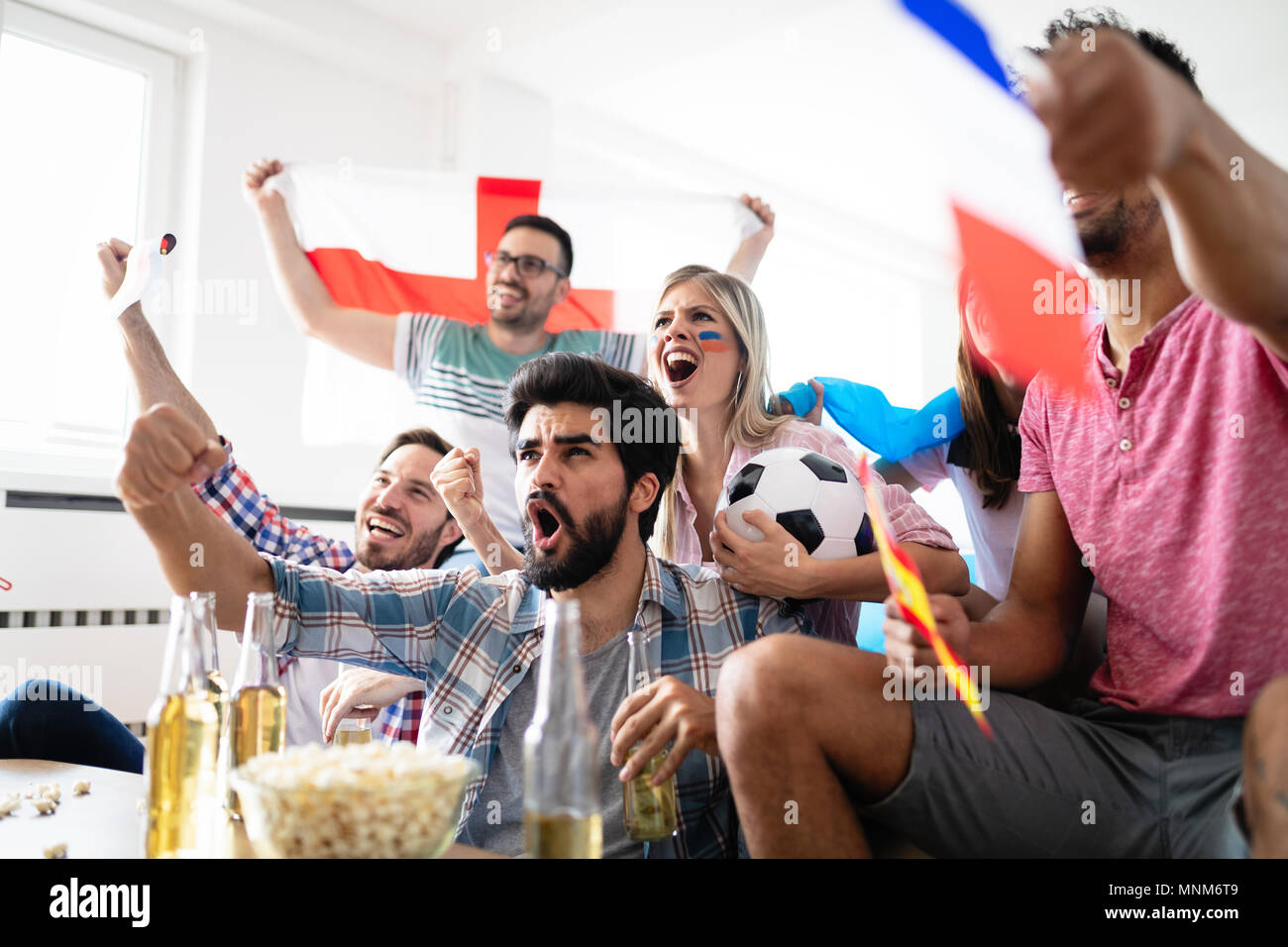 Group of multi-ethnic people celebrating football game Stock Photo