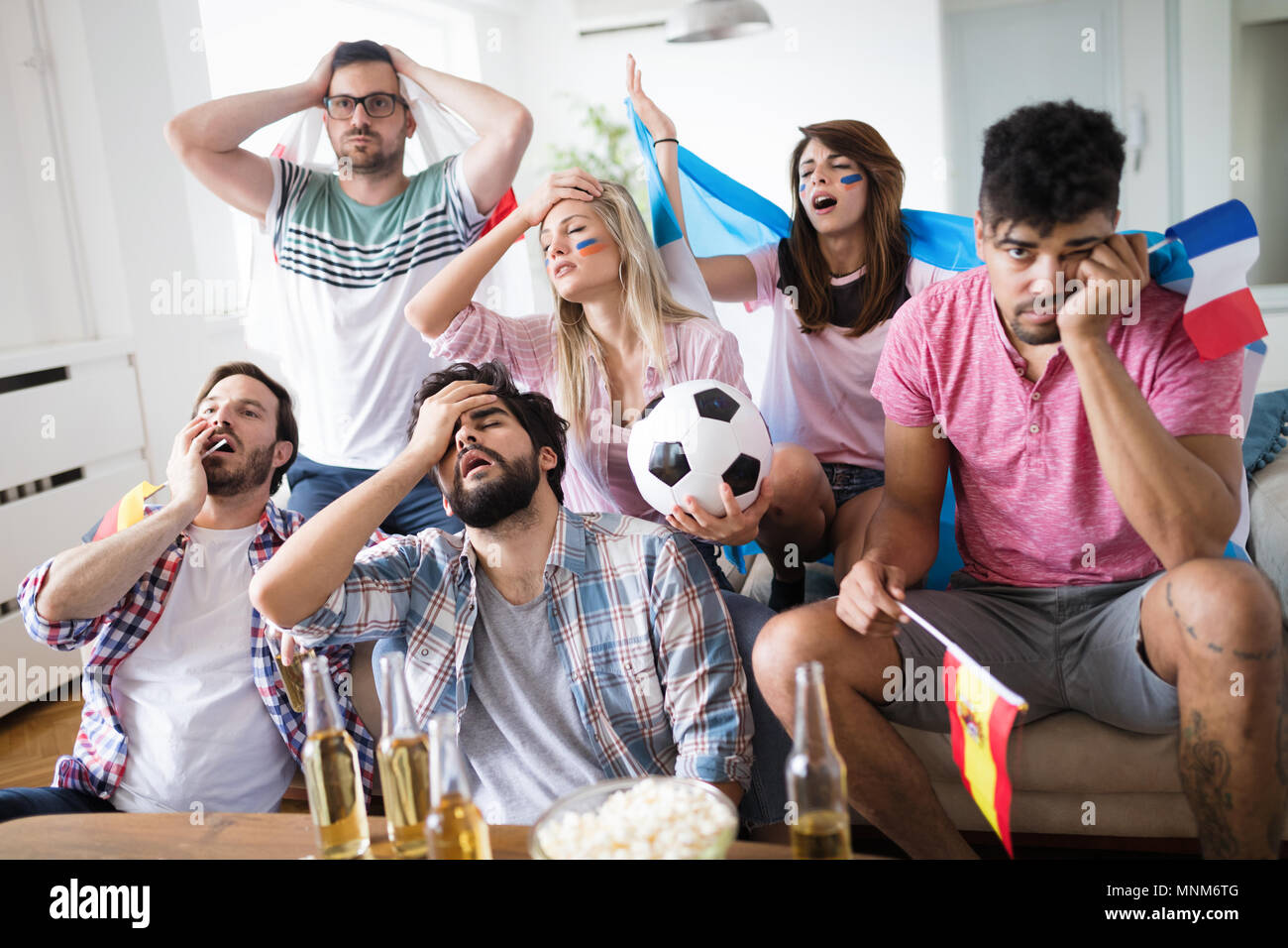 Upset friends watching football game Stock Photo Alamy