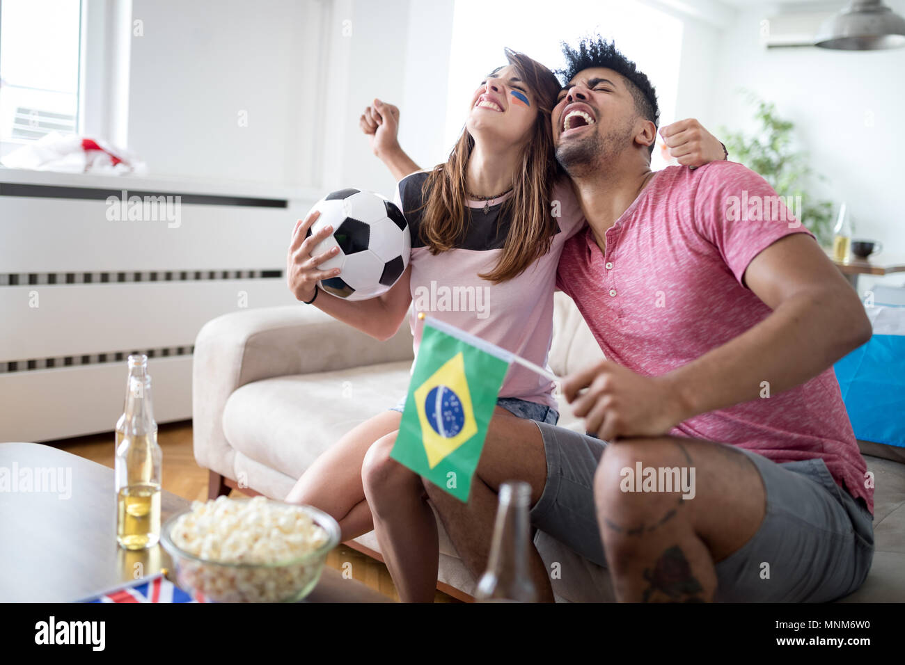 Young couple sport fans watching match on television Stock Photo Alamy